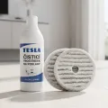 TESLA GlideStar GQ500 - two round mop pads beside a bottle of TESLA floor cleaner
